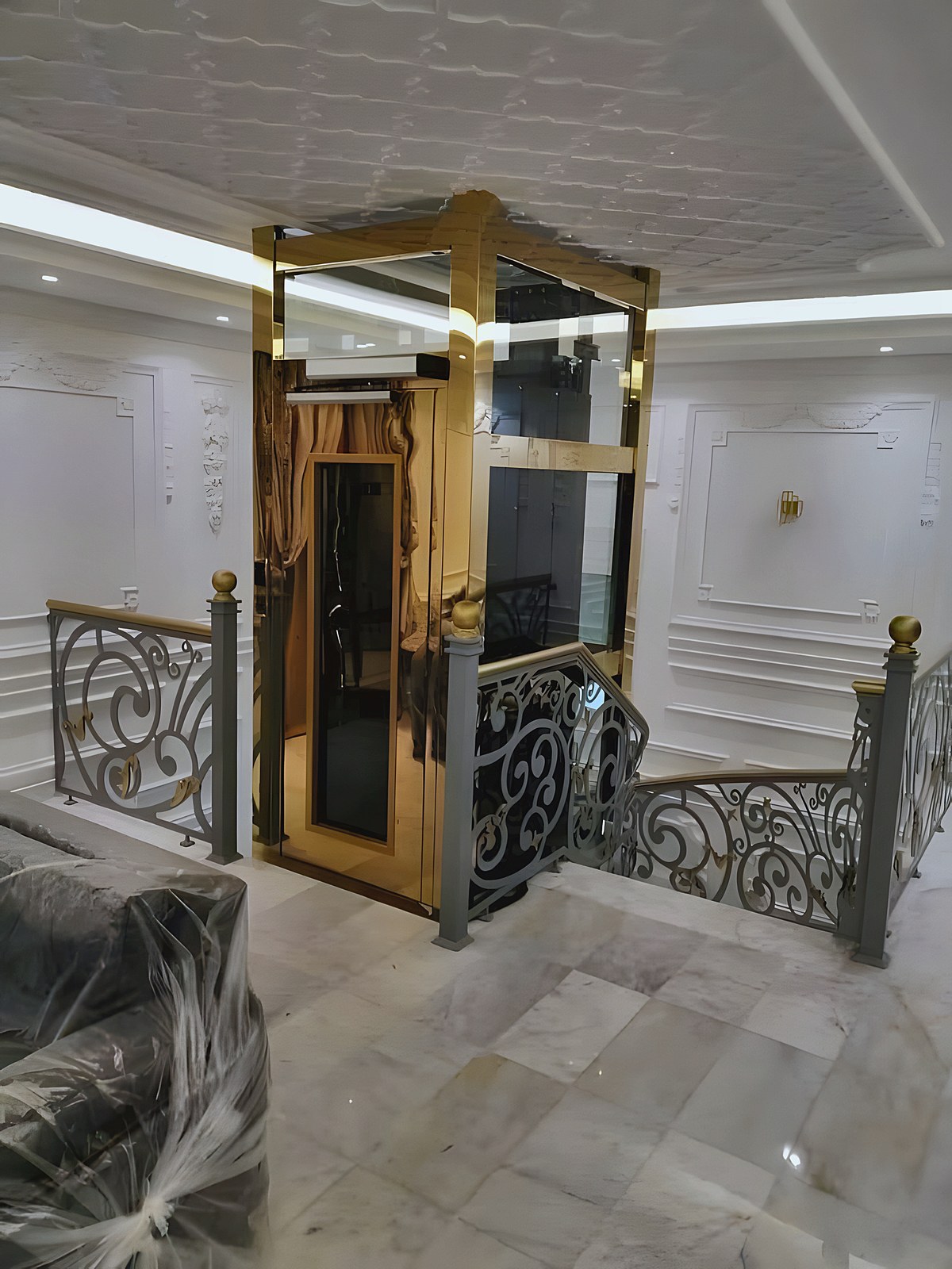 Gold glass cabin beside the wrought-iron staircase
