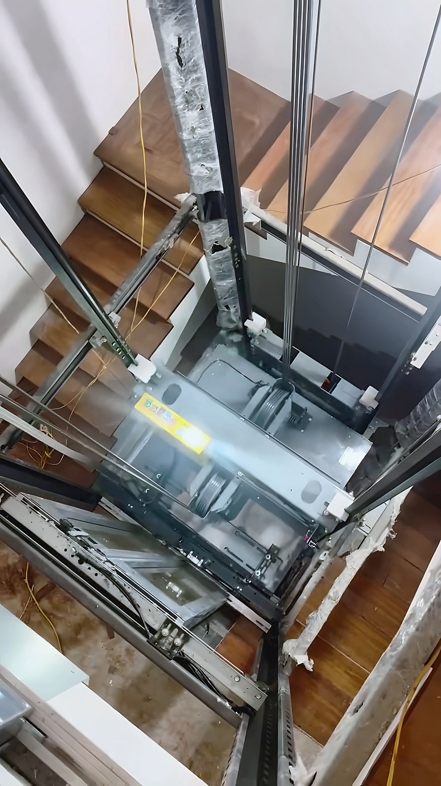 Lift rails in the stairwell — seen from above