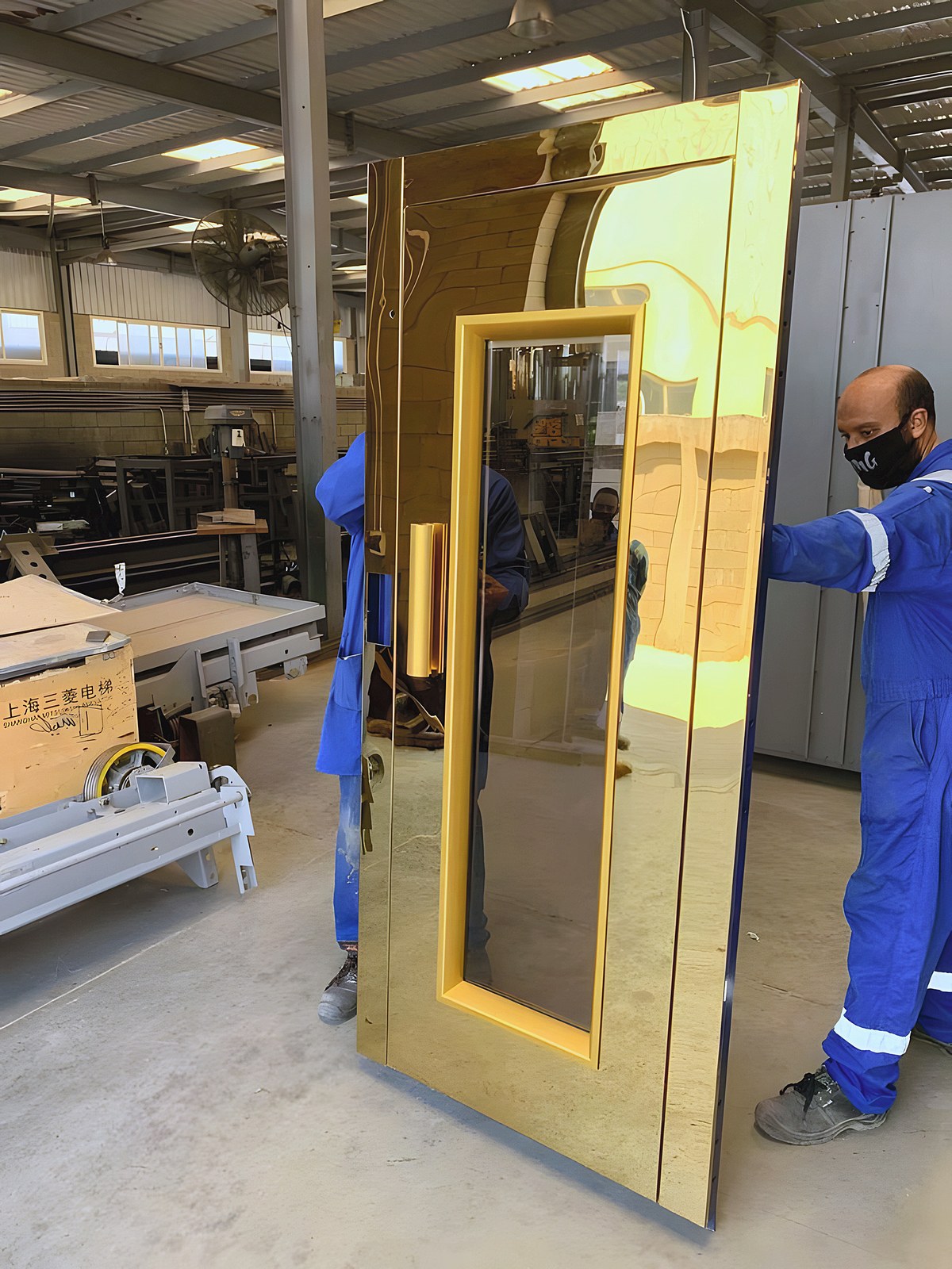 The SENSEI team moving a gold door in the factory
